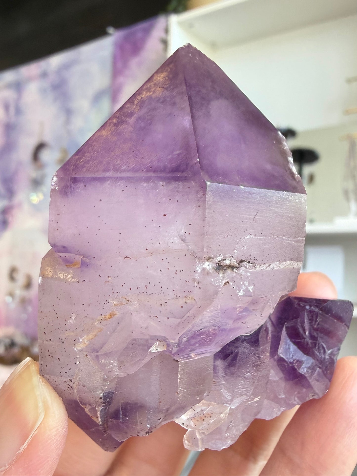 Natural elestial amethyst with skeletal structure and hematite inclusions