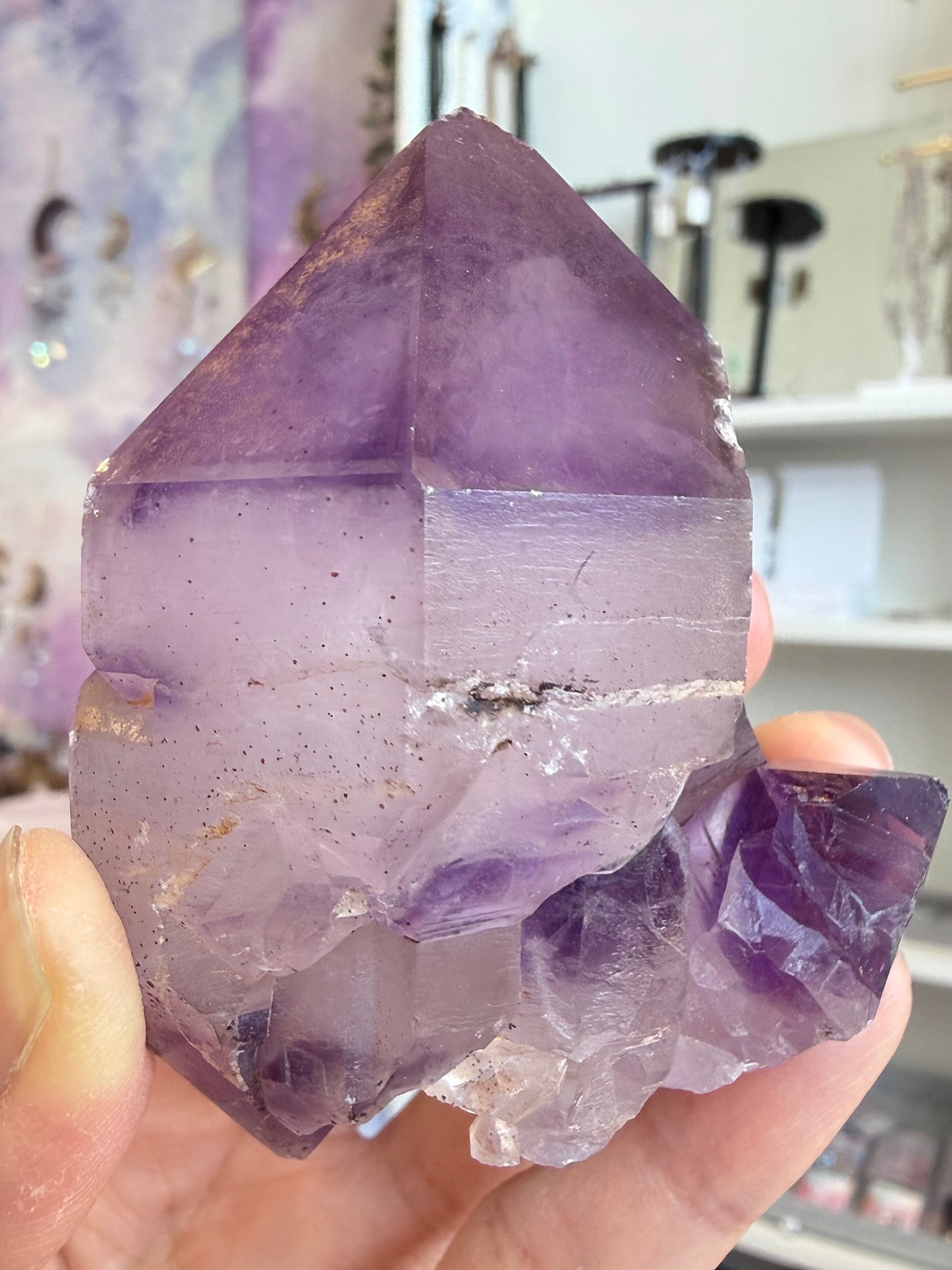 Natural elestial amethyst with skeletal structure and hematite inclusions